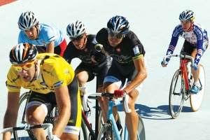 One of the most spectacular events on the track, the Madison requires skill and dexterity. Spectators witness multiple high-speed hand-sling exchanges between racers and their teammates while riding among others.  Photo courtesy of Amara Boursaw / Wheels in Focus 