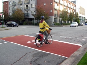 Bicycle boxes allow cyclist to go ahead of motor vehicles, providing better visibility.  Photo courtesy of City of Vancouver 