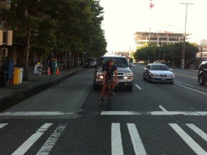 While at a stoplight, position yourself in the thru lane to allow motorists and other cyclists to use the right turning lane.  Photo by Bicycle Paper